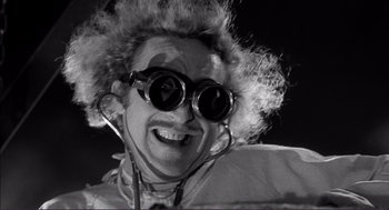 Movie still from “Young Frankenstein” (1974), directed by Mel Brooks – A man with a pair of goggles on his face; Close Up shot, Low angle