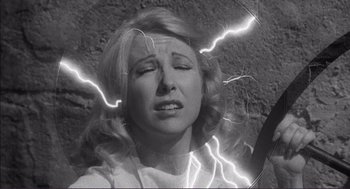 Movie still from “Young Frankenstein” (1974), directed by Mel Brooks – A black and white photo of a woman with lightening coming out of her head; Close Up shot, Overhead angle