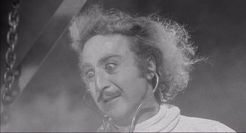 Movie still from “Young Frankenstein” (1974), directed by Mel Brooks – An old photo of a man with a strange look on his face; Close Up shot, Low angle