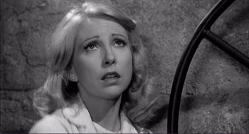 Movie still from “Young Frankenstein” (1974), directed by Mel Brooks – A black - and - white photo of a woman looking sad; Close Up shot, High angle
