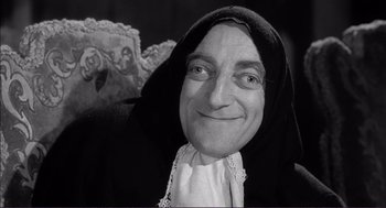 Movie still from “Young Frankenstein” (1974), directed by Mel Brooks – An old man with a beard wearing a black robe; Close Up shot, Low angle