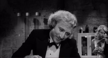 Movie still from “Young Frankenstein” (1974), directed by Mel Brooks – An older man wearing a tuxedo and a bow tie; Close Up shot, Over the shoulder angle