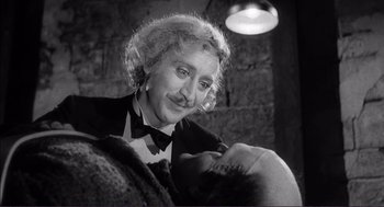Movie still from “Young Frankenstein” (1974), directed by Mel Brooks – An old photo of an older man with a mustache; Close Up shot, Low angle