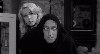 Movie still from “Young Frankenstein” (1974), directed by Mel Brooks – A man and a woman in a black and white photo; Medium shot, Over the shoulder angle