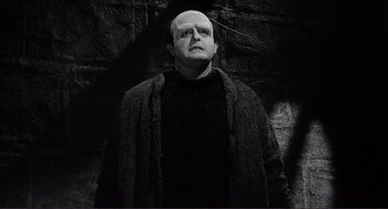 Movie still from “Young Frankenstein” (1974), directed by Mel Brooks – A black and white photo of a man with a bald head; Medium shot, Low angle