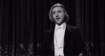 Movie still from “Young Frankenstein” (1974), directed by Mel Brooks – A black and white photo of a man in a tuxedo; Close Up shot, Low angle