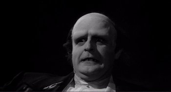 Movie still from “Young Frankenstein” (1974), directed by Mel Brooks – A man with a bald head is looking at the camera; Close Up shot, Low angle