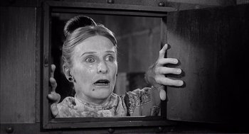 Movie still from “Young Frankenstein” (1974), directed by Mel Brooks – An older woman looking surprised through a window; Close Up shot, Low angle