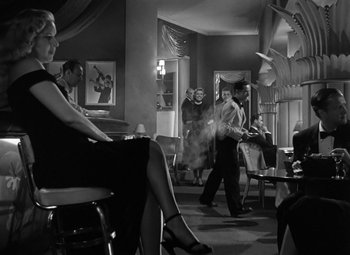 Movie still from “Young Man with a Horn” (1950), directed by Michael Curtiz – A black and white photo of people dancing in a room; Wide shot, Low angle