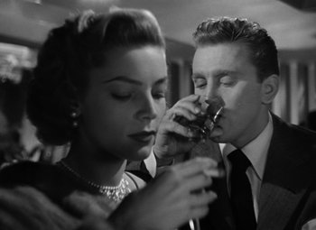 Movie still from “Young Man with a Horn” (1950), directed by Michael Curtiz – A man and a woman are drinking wine; Close Up shot, Low angle