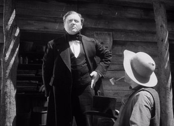 Movie still from “Young Mr. Lincoln” (1939), directed by John Ford – An old photo of a man and a young boy; Medium shot, Low angle