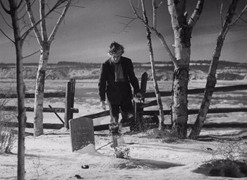 Movie still from “Young Mr. Lincoln” (1939), directed by John Ford – An old man walking in the snow near a grave; Wide shot, Over the shoulder angle