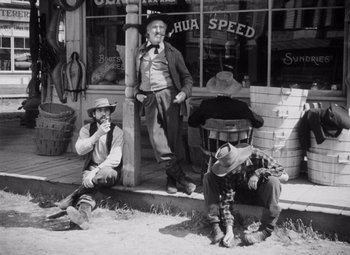 Movie still from “Young Mr. Lincoln” (1939), directed by John Ford – A group of men sitting in front of a store; Wide shot, High angle