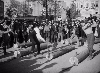 Movie still from “Young Mr. Lincoln” (1939), directed by John Ford – A group of men standing next to a pile of logs; Wide shot, High angle