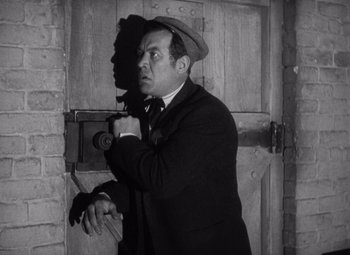 Movie still from “Young Mr. Lincoln” (1939), directed by John Ford – A black and white photo of a man in a suit and hat; Medium shot, Low angle