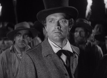 Movie still from “Young Mr. Lincoln” (1939), directed by John Ford – A black and white photo of a man wearing a top hat; Close Up shot, Low angle