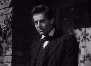 Movie still from “Young Mr. Lincoln” (1939), directed by John Ford – A black and white photo of a man wearing a suit and bow tie; Close Up shot, Low angle