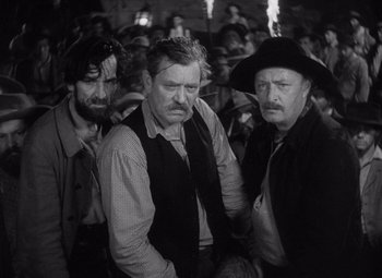 Movie still from “Young Mr. Lincoln” (1939), directed by John Ford – A group of men standing next to each other in a room; Medium shot, High angle