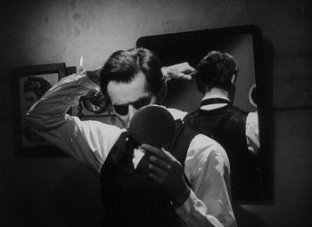 Movie still from “Young Mr. Lincoln” (1939), directed by John Ford – A man is taking a picture of himself in the mirror; Close Up shot, Over the shoulder angle