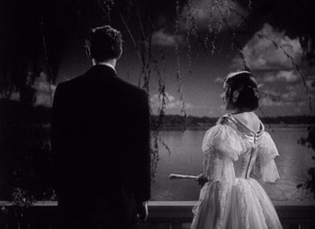 Movie still from “Young Mr. Lincoln” (1939), directed by John Ford – A man and a woman standing next to each other near a lake; Medium shot, Low angle