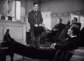 Movie still from “Young Mr. Lincoln” (1939), directed by John Ford – A group of people sitting in a room; Wide shot, Low angle