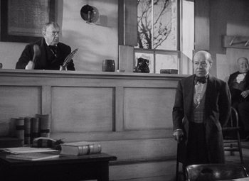 Movie still from “Young Mr. Lincoln” (1939), directed by John Ford – Two men standing in front of a desk in an office; Medium shot, Low angle