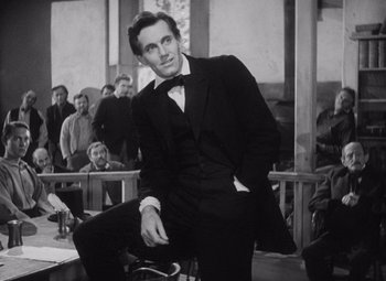 Movie still from “Young Mr. Lincoln” (1939), directed by John Ford – A black and white photo of a man in a suit and bow tie; Medium shot, Low angle