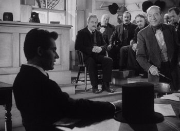 Movie still from “Young Mr. Lincoln” (1939), directed by John Ford – A group of men sitting in a room; Medium shot, Over the shoulder angle