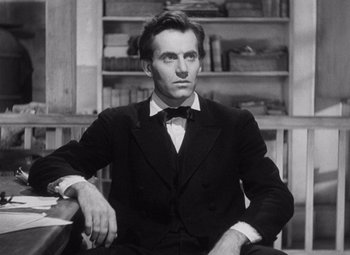 Movie still from “Young Mr. Lincoln” (1939), directed by John Ford – A black and white photo of a man in a suit and bow tie; Medium shot, Low angle