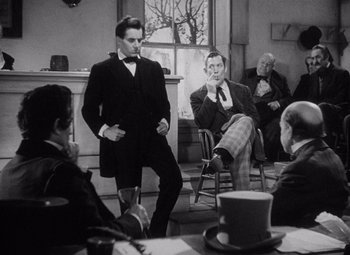 Movie still from “Young Mr. Lincoln” (1939), directed by John Ford – A group of people sitting in a room; Medium shot, Over the shoulder angle