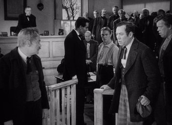Movie still from “Young Mr. Lincoln” (1939), directed by John Ford – A black and white photo of a group of people in a courtroom; Medium shot, Over the shoulder angle