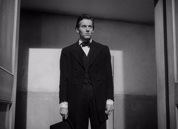 Movie still from “Young Mr. Lincoln” (1939), directed by John Ford – A black and white photo of a man in a suit; Medium shot, Low angle