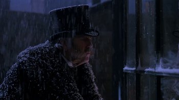 Movie still from “Young Sherlock Holmes” (1985), directed by Barry Levinson – A man wearing a top hat sitting in the rain; Close Up shot, Low angle