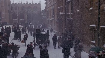 Movie still from “Young Sherlock Holmes” (1985), directed by Barry Levinson – A crowd of people walking down a street in the snow; Extreme Wide shot, High angle