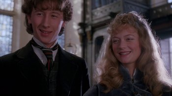 Movie still from “Young Sherlock Holmes” (1985), directed by Barry Levinson – A man standing next to a woman wearing a suit; Close Up shot, Low angle