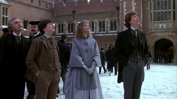 Movie still from “Young Sherlock Holmes” (1985), directed by Barry Levinson – A group of people standing in the middle of a street; Medium shot, Low angle