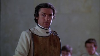 Movie still from “Young Sherlock Holmes” (1985), directed by Barry Levinson – A man wearing a brown and white apron; Close Up shot, Low angle