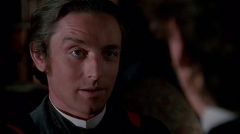 Movie still from “Young Sherlock Holmes” (1985), directed by Barry Levinson – A person wearing a suit and tie; Close Up shot, Over the shoulder angle