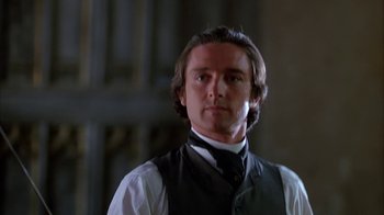 Movie still from “Young Sherlock Holmes” (1985), directed by Barry Levinson – A person wearing a vest and a tie; Close Up shot, Low angle