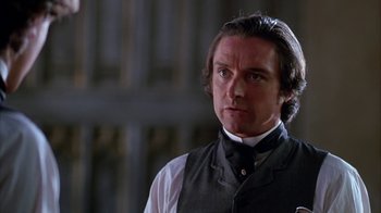 Movie still from “Young Sherlock Holmes” (1985), directed by Barry Levinson – A person wearing a vest and a tie; Close Up shot, Over the shoulder angle