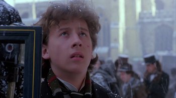 Movie still from “Young Sherlock Holmes” (1985), directed by Barry Levinson – A young man in a black jacket and a red scarf; Close Up shot, Low angle