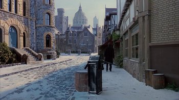 Movie still from “Young Sherlock Holmes” (1985), directed by Barry Levinson – A street scene with a person standing next to a trash can; Extreme Wide shot, High angle