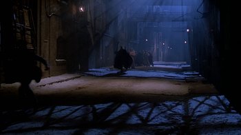 Movie still from “Young Sherlock Holmes” (1985), directed by Barry Levinson – A street scene with a person riding a skate board; Extreme Wide shot, High angle
