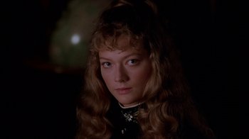 Movie still from “Young Sherlock Holmes” (1985), directed by Barry Levinson – A person with long curly hair; Close Up shot, High angle