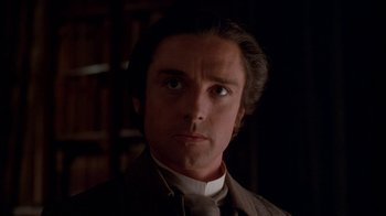 Movie still from “Young Sherlock Holmes” (1985), directed by Barry Levinson – A person wearing a suit and tie; Close Up shot, Low angle