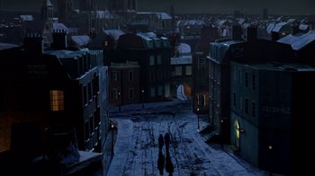 Movie still from “Young Sherlock Holmes” (1985), directed by Barry Levinson – Two people walking down a snow covered street at night; Extreme Wide shot, High angle
