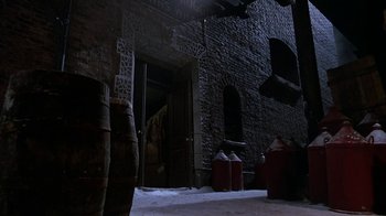 Movie still from “Young Sherlock Holmes” (1985), directed by Barry Levinson – A brick building with a fire hydrant in front of it; Extreme Wide shot, High angle