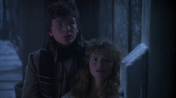 Movie still from “Young Sherlock Holmes” (1985), directed by Barry Levinson – A man and a woman standing next to each other; Close Up shot, Over the shoulder angle