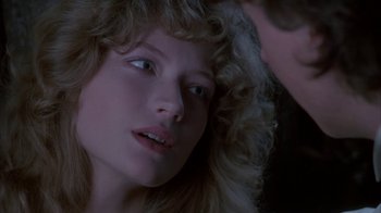 Movie still from “Young Sherlock Holmes” (1985), directed by Barry Levinson – A young woman with blonde curly hair looking at the camera; Close Up shot, Over the shoulder angle