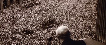 Movie still from “Young Winston” (1972), directed by Richard Attenborough – An old photo of a man speaking to a large crowd; Extreme Wide shot, High angle